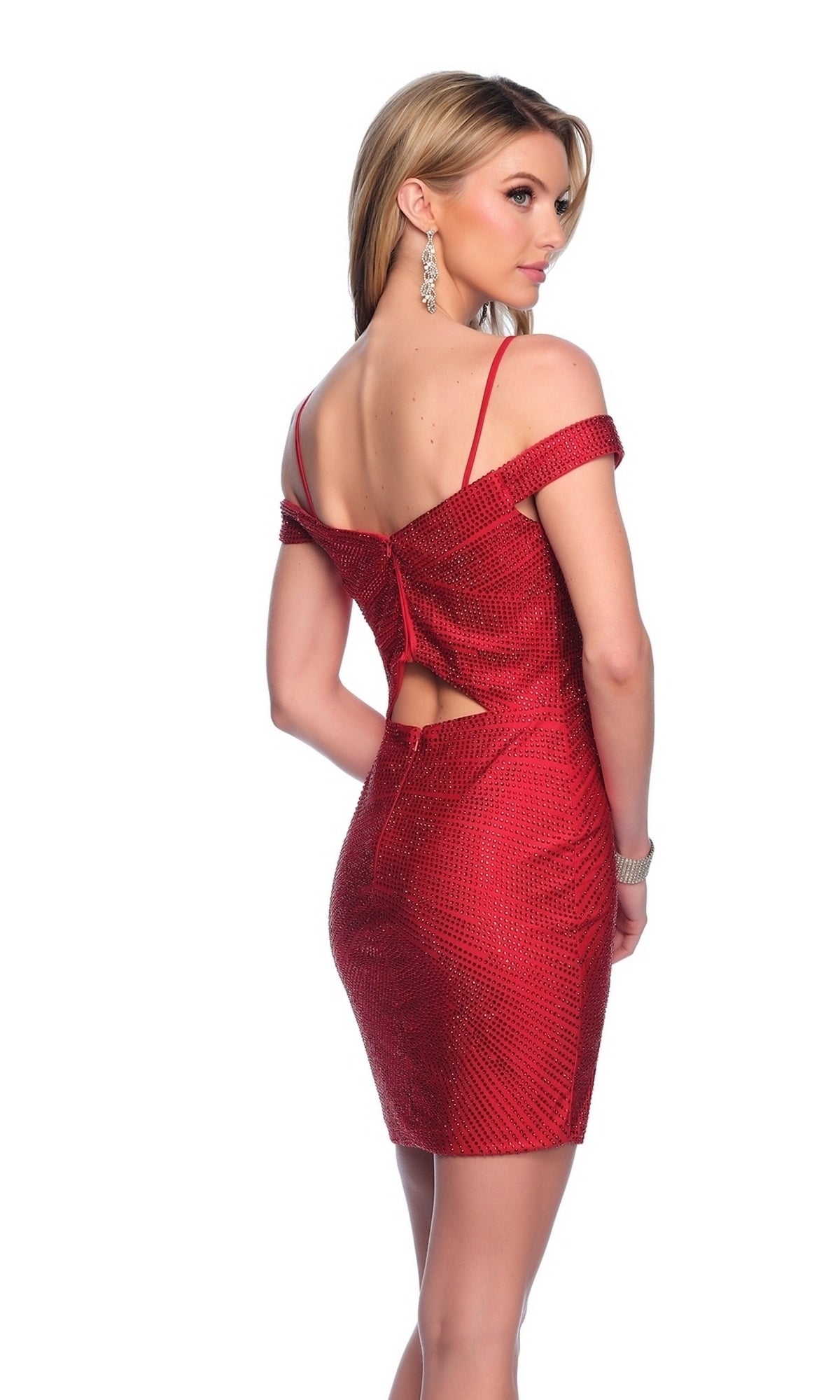 A woman wears the Dave & Johnny Tight Red Short Hoco Dress 11916 with thin straps, off-the-shoulder neckline, and open back, accessorized with silver earrings, standing against a white background.